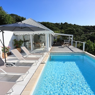 Soak up the sun by your private pool, where tropical breezes and mountain views create the perfect backdrop for relaxation.