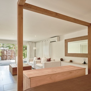 Unwind in your serene suite where natural wood and white tones create a spa-like sanctuary with garden views.