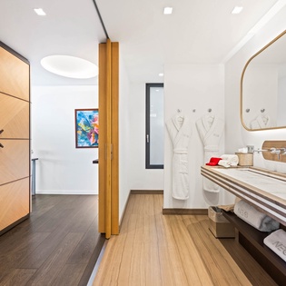 Step into your luxurious spa-style bathroom featuring premium amenities, plush robes, and elegant wood finishes for ultimate relaxation.