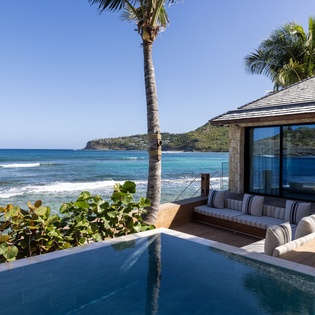 Your private infinity pool melts into ocean views, while plush lounge seating invites you to soak up tropical paradise.