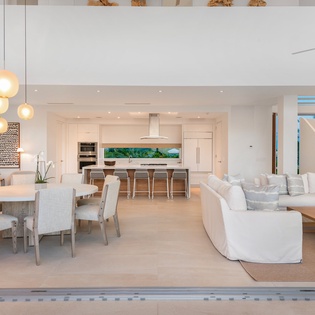 Step into your stunning open-plan sanctuary where sleek kitchen, elegant dining, and plush living spaces flow seamlessly together for pure relaxation.
