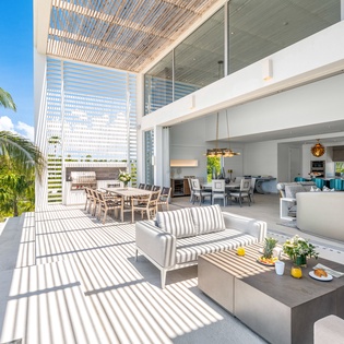 Step into your tropical paradise where modern luxury meets island life. This stunning open-concept space flows seamlessly from kitchen to terrace.