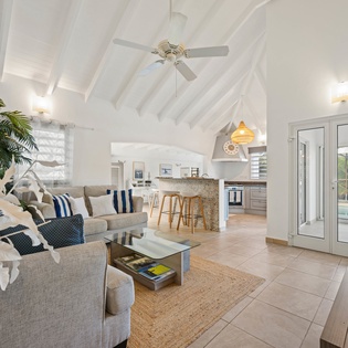 Relax in your bright, airy living space with soaring ceilings, modern coastal décor, and open-plan design perfect for unwinding.