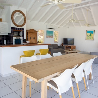 Gather around your spacious dining table in this bright, open-plan villa where kitchen, dining, and living flow seamlessly together.