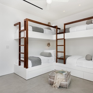Custom bunk beds with plush linens create a cozy sleep sanctuary where you'll drift off peacefully after adventure-filled days.