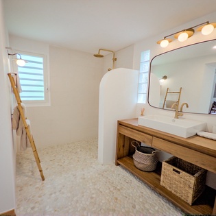 Your beautifully designed bathroom features a walk-in shower, warm wood vanity, and natural light for a refreshing, spa-like escape.