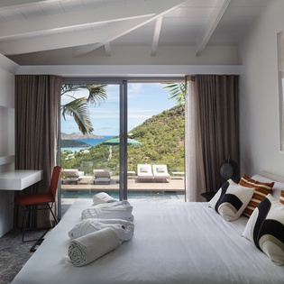 Wake up to breathtaking ocean and mountain views from your king bed, with direct terrace access to your private pool.