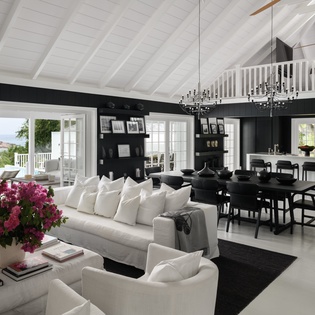 Sink into plush sofas beneath soaring beams while your gourmet kitchen awaits culinary adventures in this sophisticated retreat.