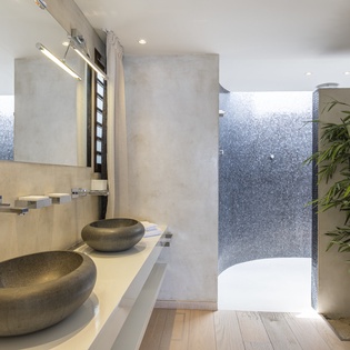 Unwind in this spa-inspired sanctuary with natural stone vessel sinks, rainfall shower, and serene bamboo accents that invite relaxation after your adventures.
