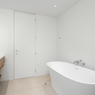 Immerse yourself in this sleek sanctuary with a luxurious freestanding tub for pure relaxation after your adventures.