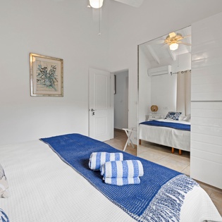 Unwind in your serene bedroom sanctuary with crisp linens and charming coastal touches that invite peaceful rest.