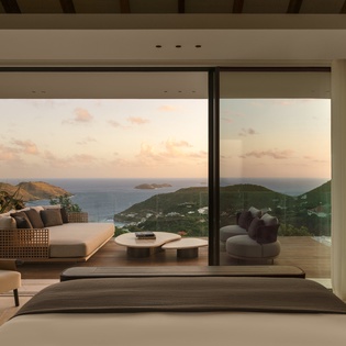 Wake up to breathtaking ocean and mountain views from your luxurious bedroom, where floor-to-ceiling windows frame the perfect Caribbean sunrise.