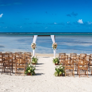 Beautiful beachfront wedding ceremony setup with white sand, turquoise waters, and tropical surroundings creating the perfect romantic backdrop.