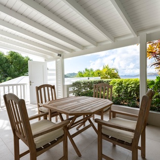 Enjoy tropical dining on your private terrace with ocean glimpses through lush palms.