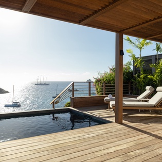 Unwind on your private deck with infinity pool overlooking sparkling ocean views, complete with luxurious loungers for ultimate relaxation.