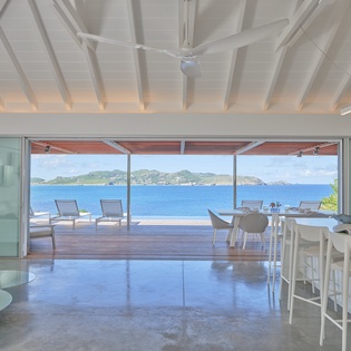 Step into your open-plan paradise where modern elegance meets breathtaking ocean views through floor-to-ceiling windows.