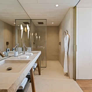 Indulge in your luxurious spa-style bathroom with dual sinks, elegant marble counters, and a spacious glass shower that transforms your daily routine into pure relaxation.