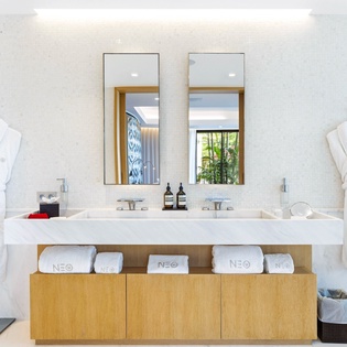 Step into your spa-like bathroom with dual vanities, plush robes, and premium amenities waiting to pamper you.