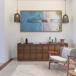 Unwind in your stylish living space, where coastal-inspired artwork and warm wood tones create a serene retreat for your stay.