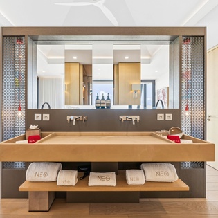 Step into your luxurious bathroom featuring a stunning floating vanity with dual sinks and beautiful mosaic tile accents.