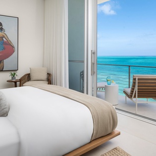 Wake up to stunning turquoise waters just steps from your bed, with a private balcony overlooking the ocean.