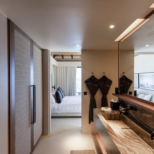 Slip into the luxurious robes provided as you explore your spacious suite featuring elegant wardrobes and live-edge wood vanity.