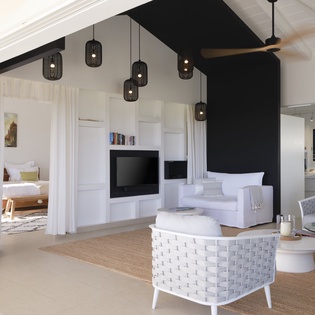 Unwind in your sophisticated living space with vaulted ceilings, elegant pendant lighting, and serene white décor that creates the perfect retreat.
