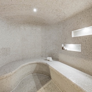 Unwind in your private steam room, where warm mosaic tiles and gentle lighting create the perfect sanctuary for relaxation.
