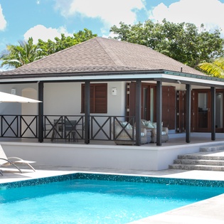 Modern tropical villa with private pool, shaded terrace, and lush palm surroundings—your perfect island getaway awaits.