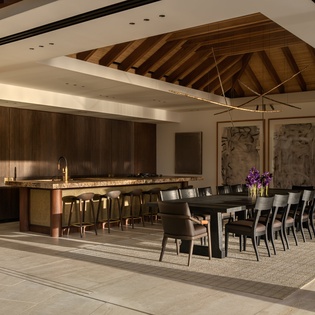 Gather with loved ones in this stunning open-plan space where soaring wood beams frame your culinary adventures and memorable meals together.