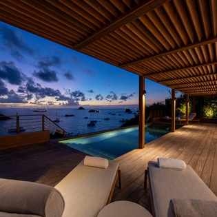 Unwind on your private infinity terrace as twilight paints the sea in magical hues, with loungers perfectly positioned for stargazing.