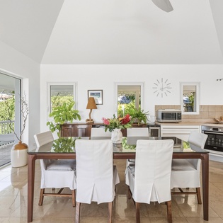 Gather around your open-plan dining area where natural light streams through garden views, creating the perfect setting for memorable meals.