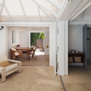 Airy vaulted ceilings and open doorways invite you to unwind in this bright, beautifully connected living space, where natural textures and clean design make every moment feel effortlessly serene.