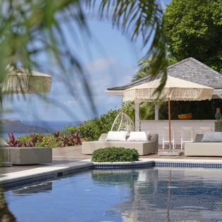 Luxury poolside paradise with tropical elegance and ocean views awaiting your arrival.