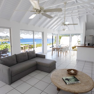 Relax in your bright, airy living space with stunning ocean views and seamless outdoor access where Caribbean breezes flow freely.