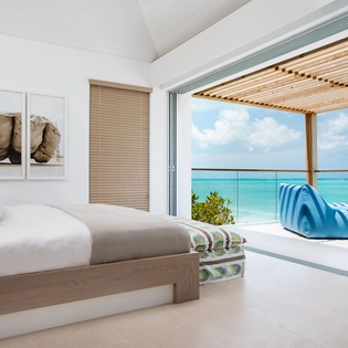Wake up to breathtaking turquoise waters from your oceanfront bedroom, where floor-to-ceiling windows frame paradise.