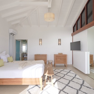 Unwind in your bright, airy bedroom with warm wood accents, crisp linens, and thoughtful touches that create a serene retreat.