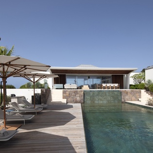 Sleek modern villa with stunning pool and ocean views creates your perfect tropical escape.
