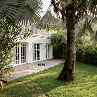 Step onto your private deck surrounded by swaying palms and lush tropical gardens, where French doors open to your peaceful retreat.