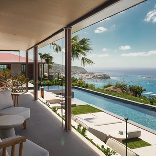 Relax in your private covered terrace with breathtaking ocean vistas, infinity pool access, and comfortable seating for ultimate tropical luxury.