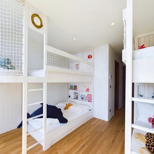 Your family's adventure awaits in this playful bunk room where kids can climb, read, and dream in their own cozy hideaway.
