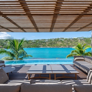 Unwind in your private infinity pool terrace where Caribbean blues meet endless comfort and tropical palm shadows dance overhead.