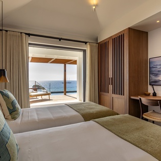 Wake to ocean breezes in your serene twin bedroom, where panoramic sea views and modern comfort create perfect mornings.