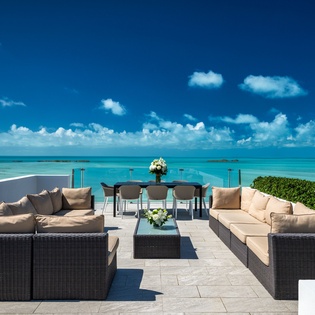 Stunning rooftop terrace overlooks turquoise waters and endless horizon. Luxurious seating and dining areas create your perfect oceanfront escape.