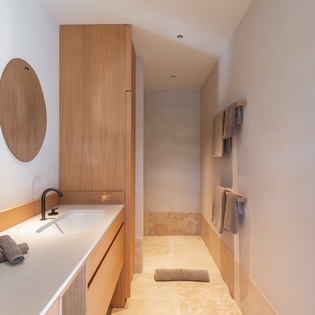 Unwind in your spa-like bathroom with warm wood tones, a soaking tub, and luxurious amenities for the perfect end to your day.