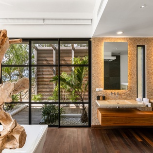 Luxurious bathroom with dual vanities and stunning garden views creates your perfect morning retreat.