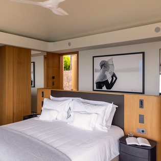 Your modern bedroom sanctuary features pristine linens and sleek wood finishes, creating the perfect retreat for restful nights.