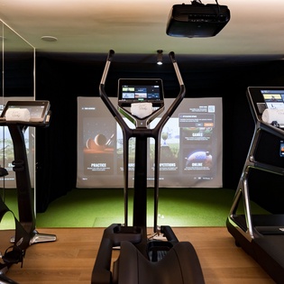 Stay active in your modern fitness center featuring treadmills, elliptical machines, and interactive entertainment screens to keep your workout engaging.