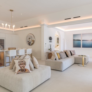 Step into your elegant open-plan sanctuary where modern luxury meets comfort, featuring plush seating and sleek kitchen perfect for memorable stays.