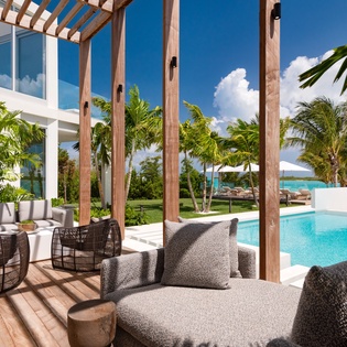Sink into plush poolside seating where tropical breezes meet crystal waters—your perfect spot to unwind in paradise.